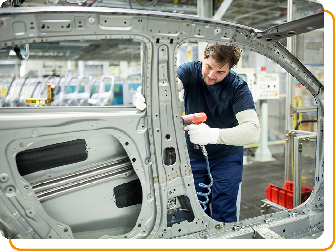 Image of a car mechanic building a car in a factory