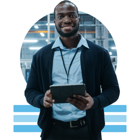 Image of a smiling person holding a tablet in a car factory