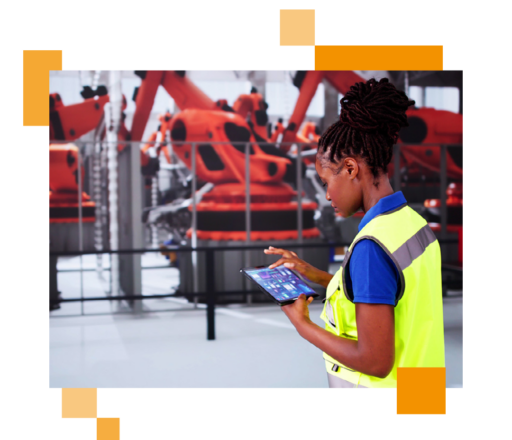 Image of a person working in a car factory looking at data on a tablet