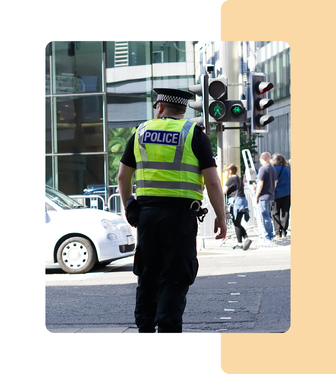 Image of a police officer stood on a high street