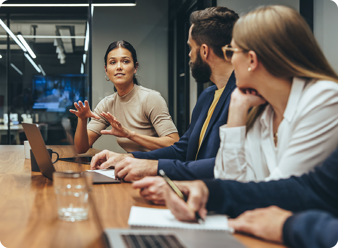 Image of a group of coworkers talking in a meeting