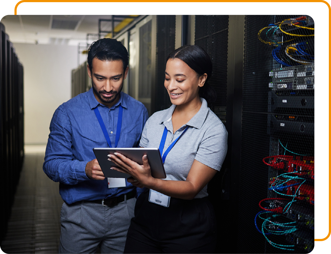 Image of two IT specialists stood in a server room