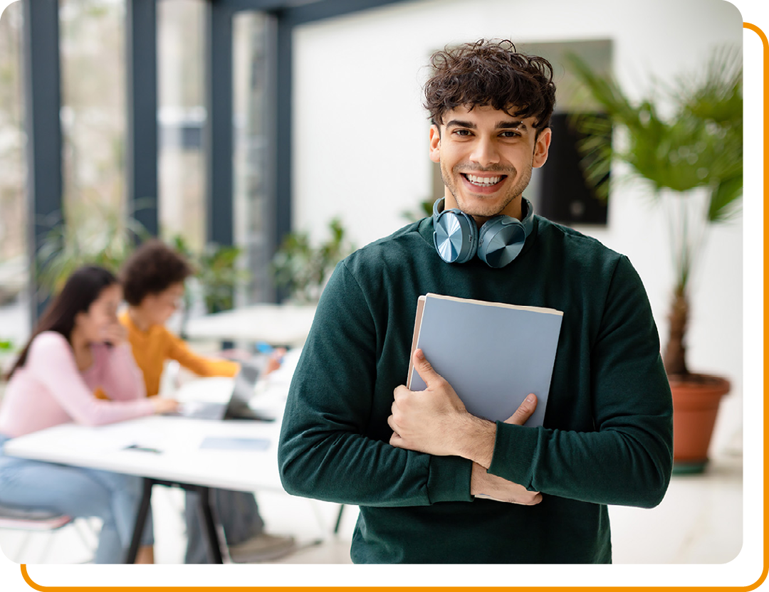 Image of a student stood holding a notebook