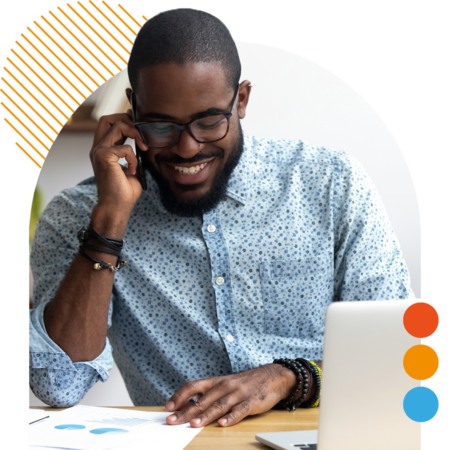 Image of a smiling professional working on a laptop