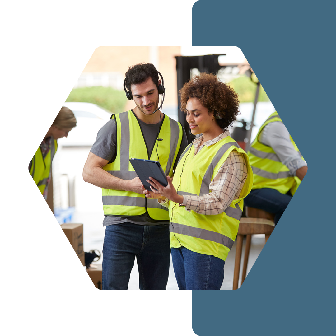 Image of two retail workers on a tablet conversing