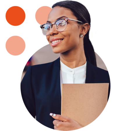 Image of a smiling business professional stood outside of a government building