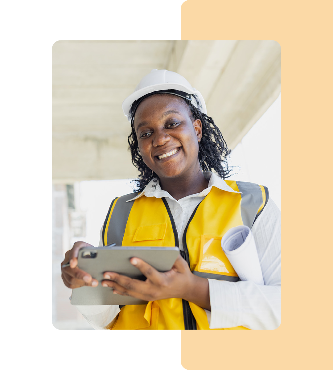 Image of a smiling construction worker holding a tablet