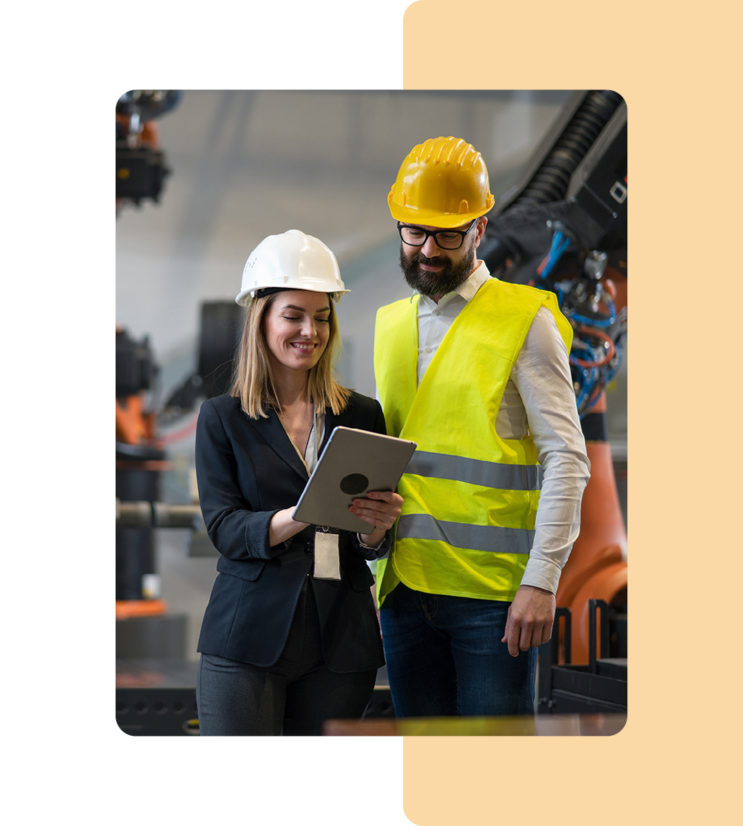 Image of two workers holding a tablet in a manufacturing factory