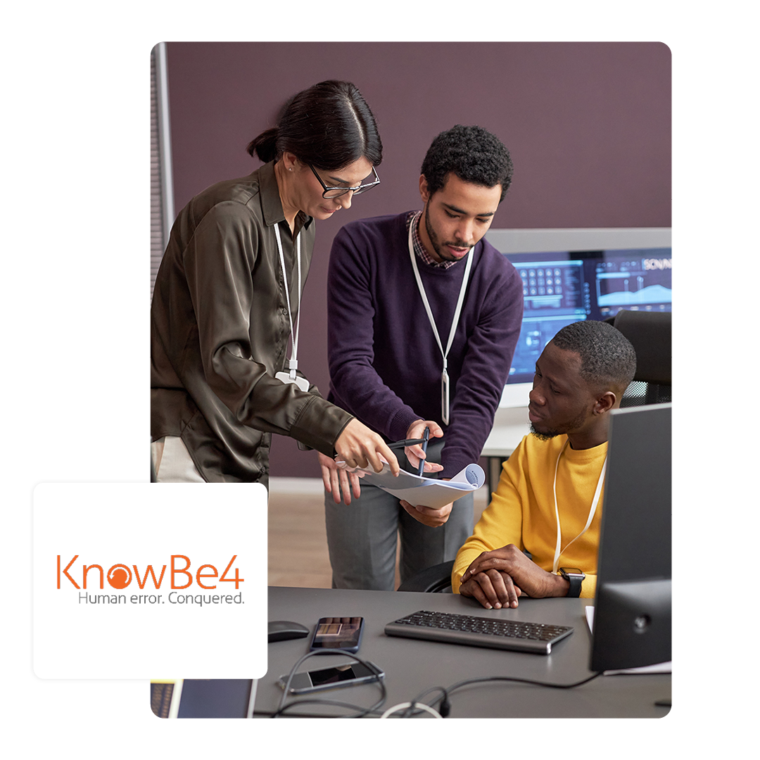 3 people teaching each other sat round a desk