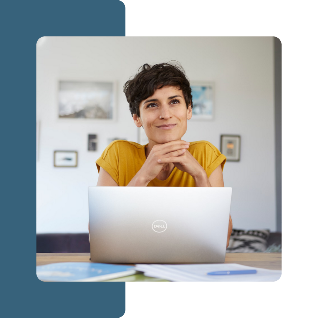 Image of a person sat at a desk with a laptop