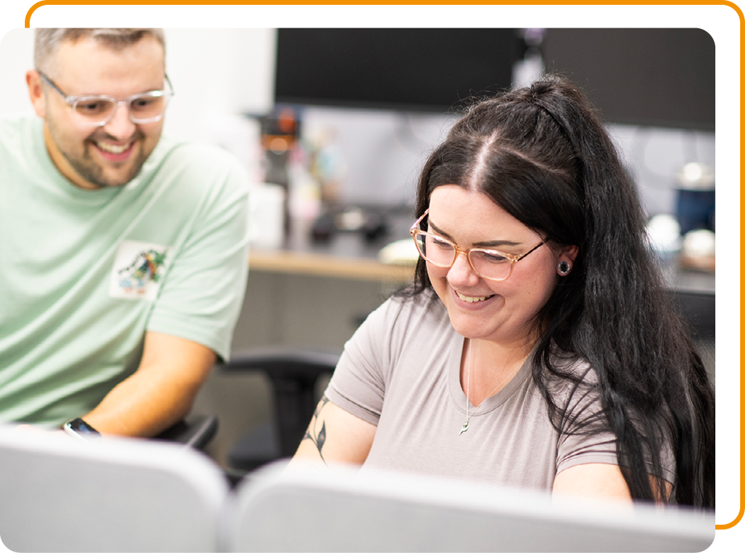 Image of two Phoenix Software employees conversing at a desk