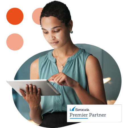 Image of a business professional working on a tablet with our Barracuda Premier Partner logo