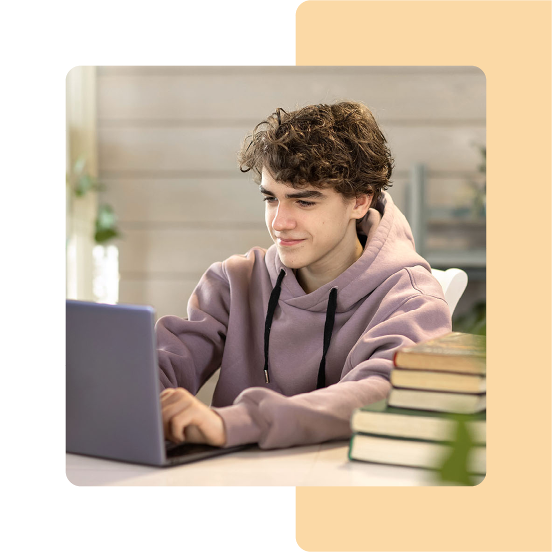 Image of a student sat working on a laptop