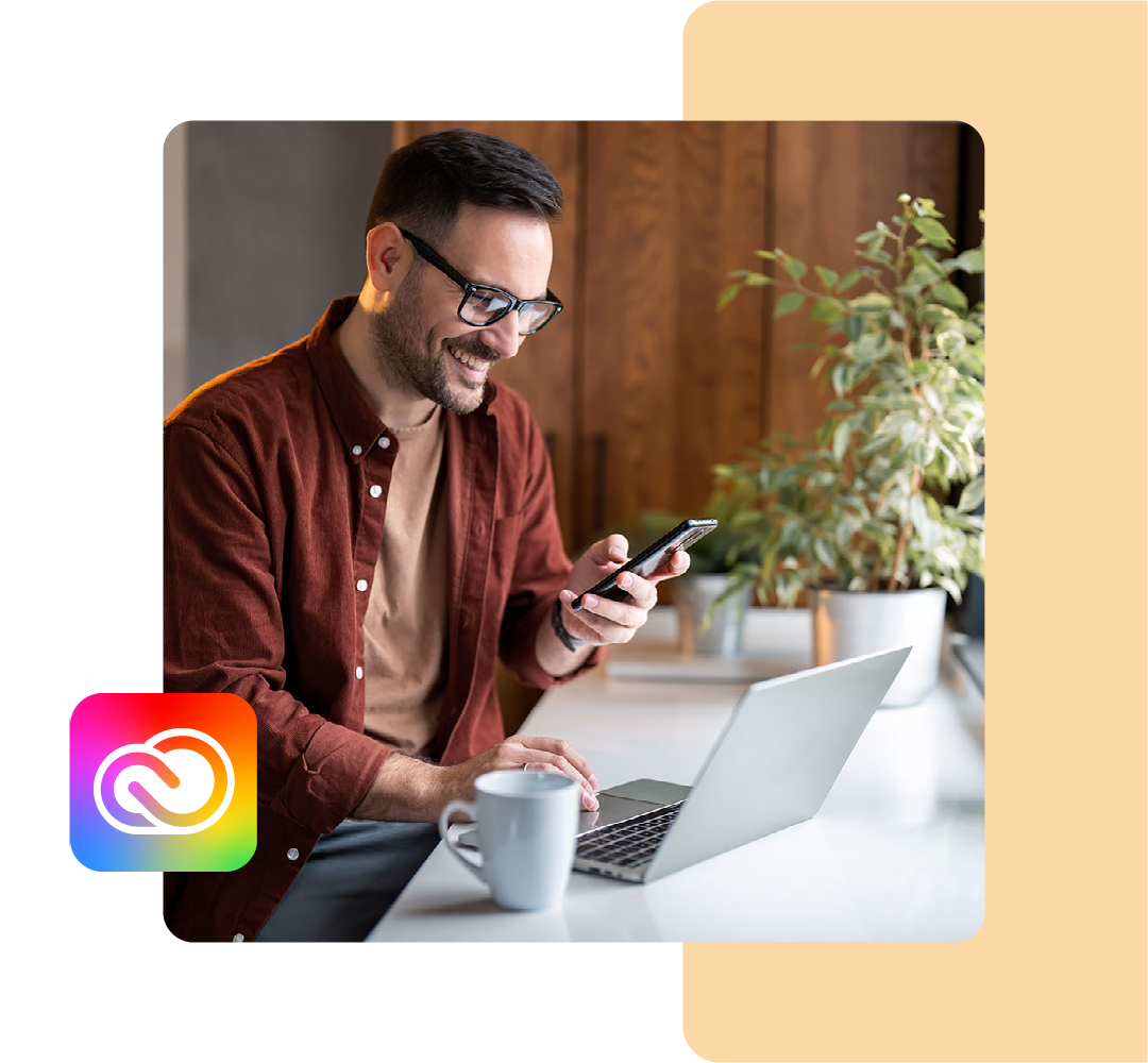 Image of a business professional working on a laptop with the Adobe Creative Cloud logo