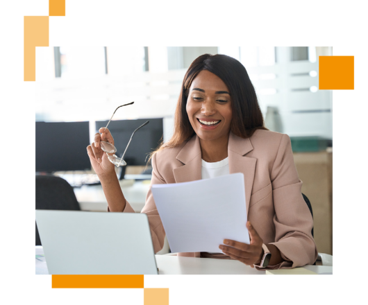 Image of a business professional sat at a desk looking at information on paper