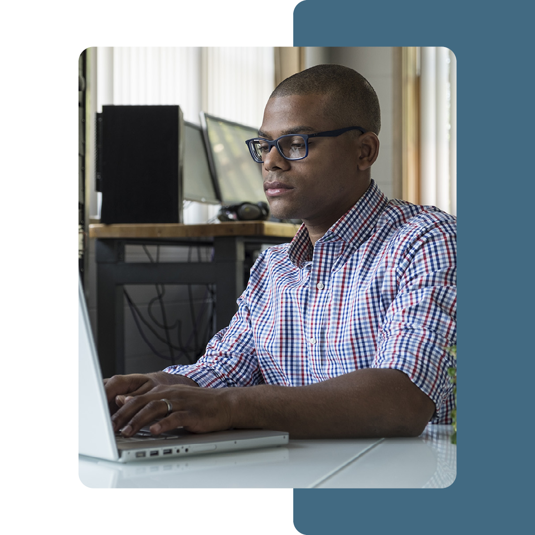 Image of an IT professional working on a laptop