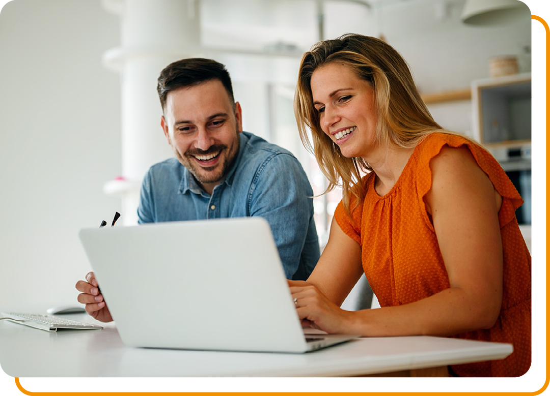 Image of two people working together on a laptop