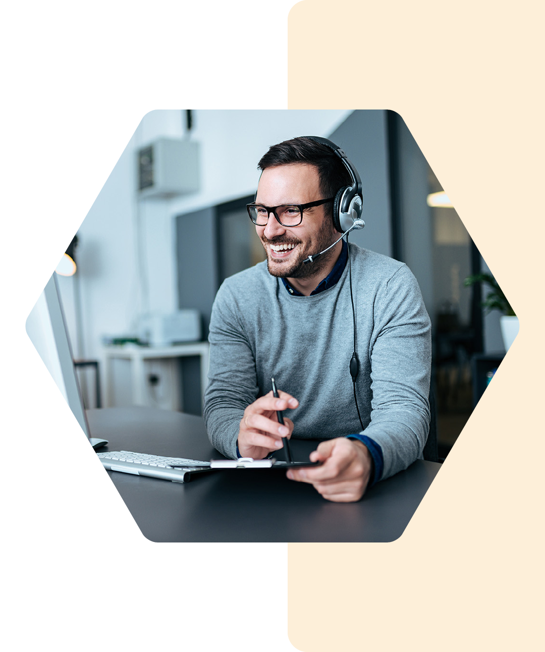 Image of a smiling IT professional working on a laptop