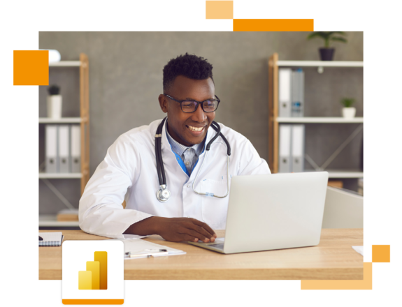 Image of a smiling doctor working on a laptop in an office