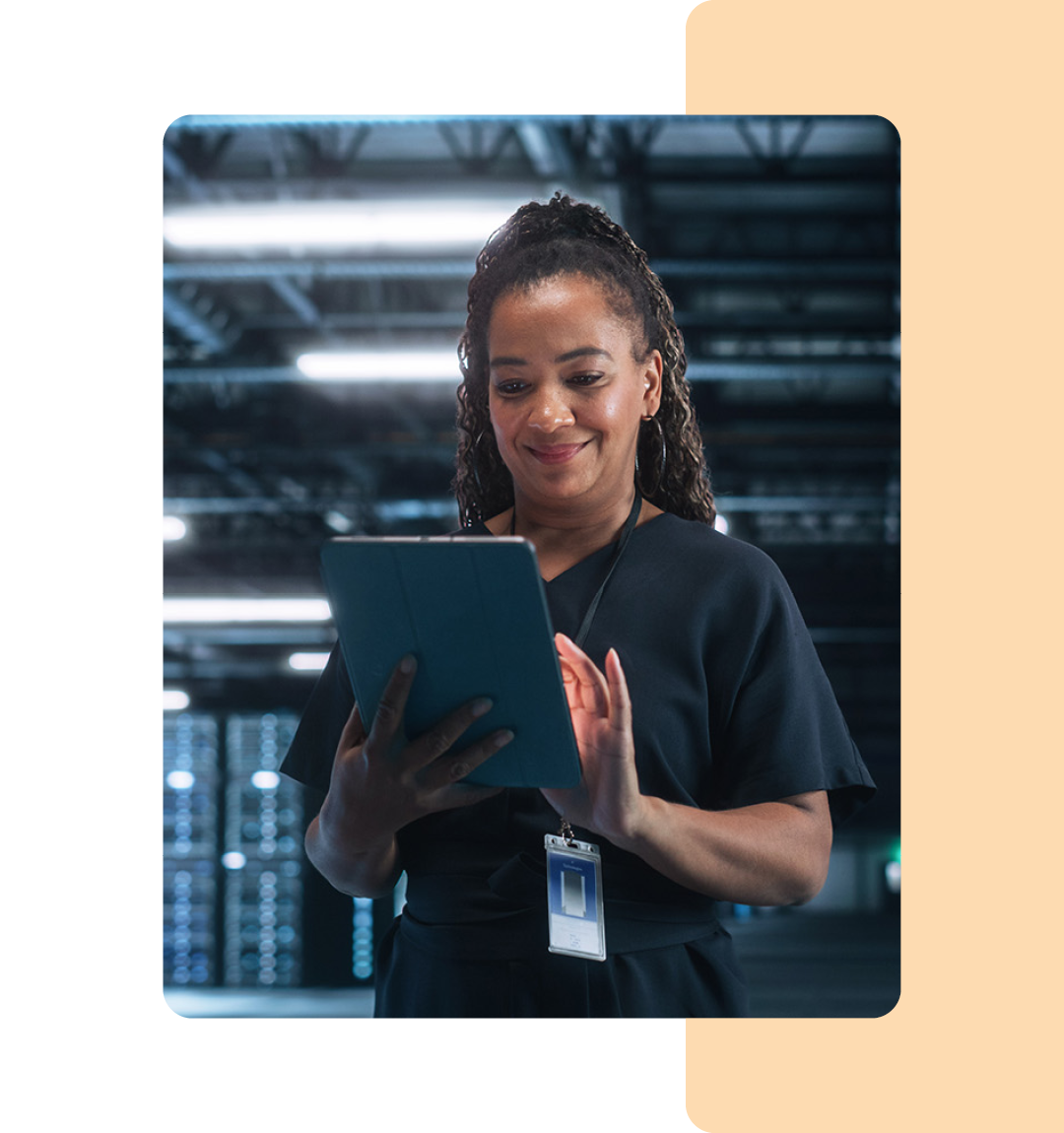 Image of an IT professional working on a tablet in a data storage room