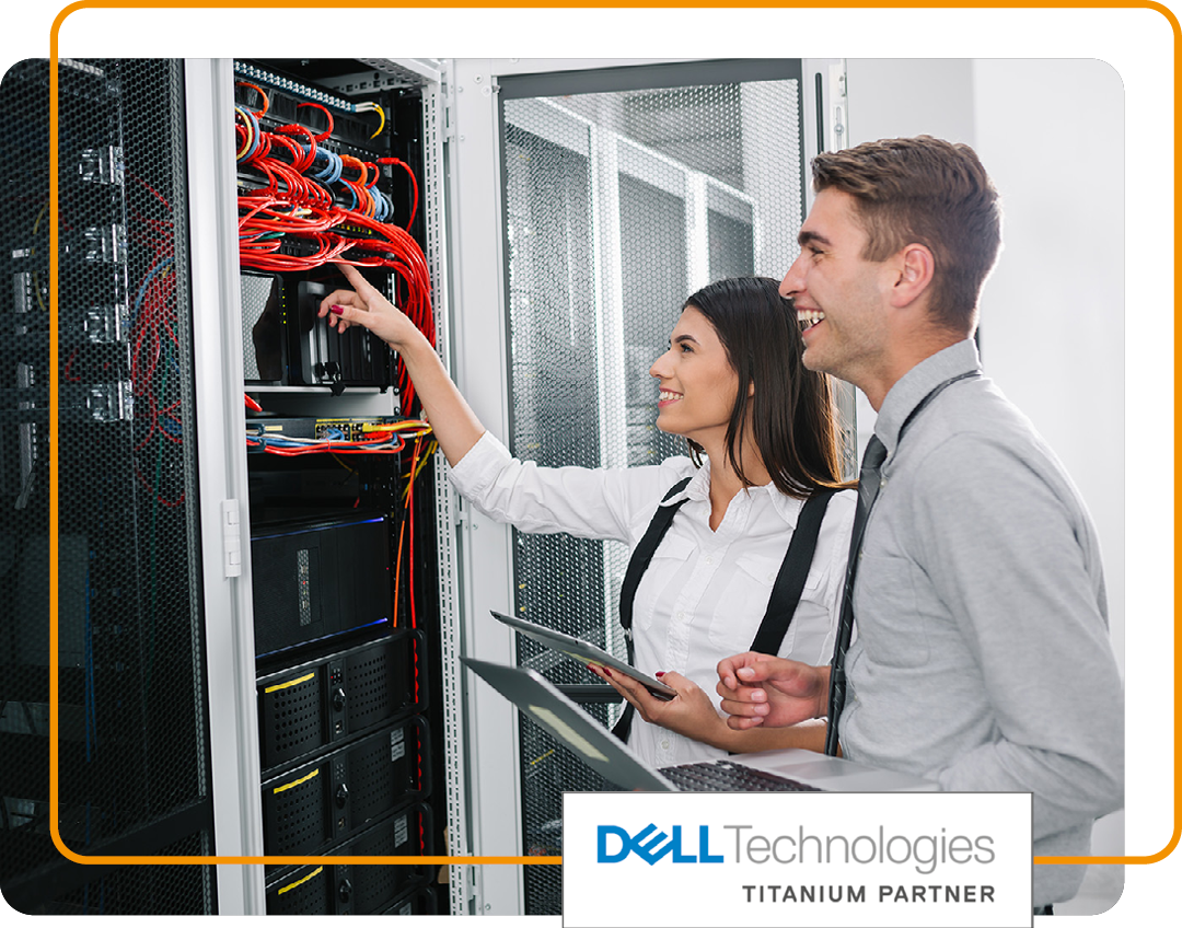 Image of two IT professionals working in a data storage room with our Dell Technologies Titanium Partner logo