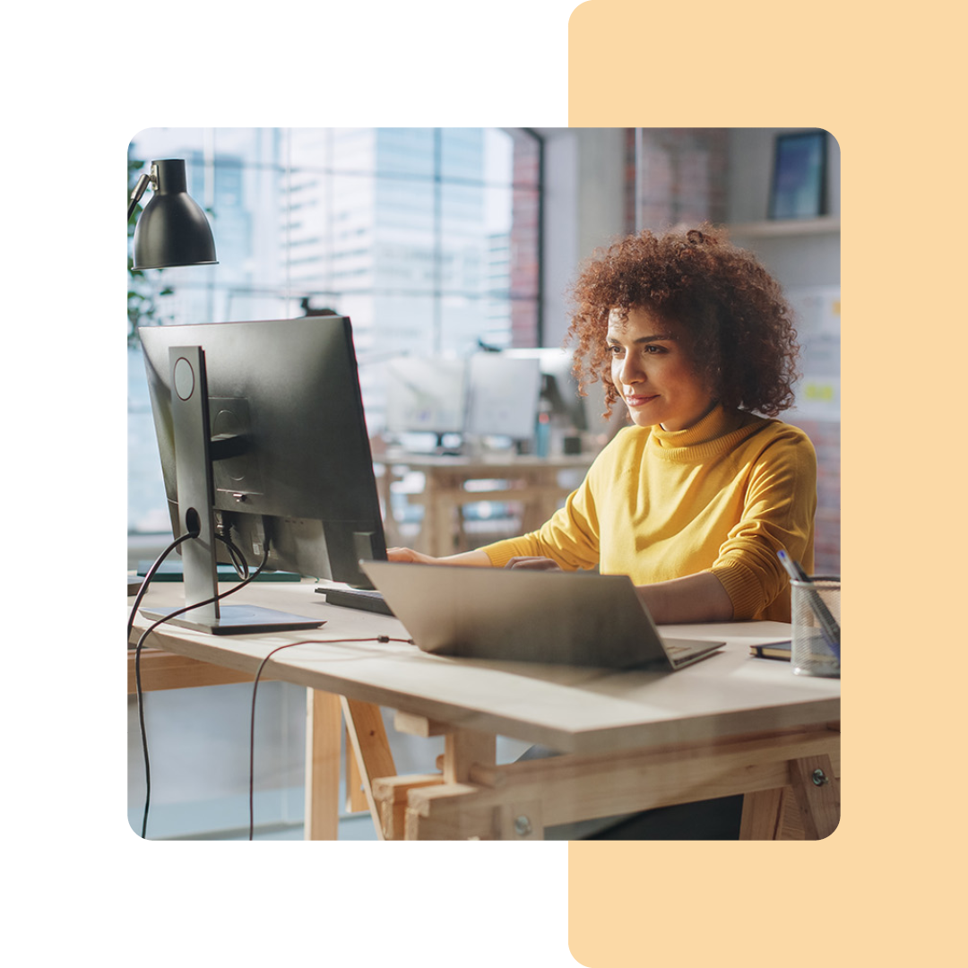 Image of a person working on a desktop computer