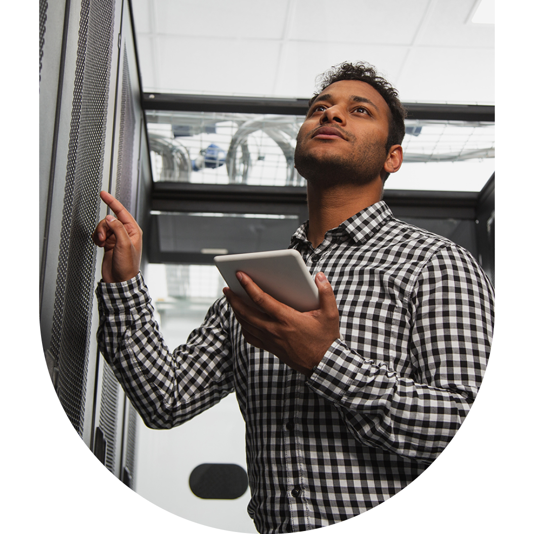 Image of an IT professional walking through a server room