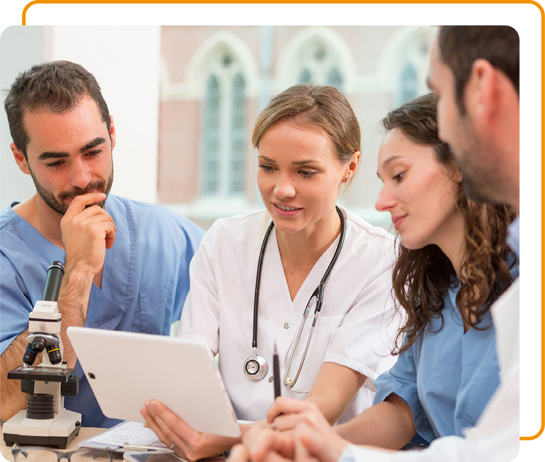 Image of a group of doctors looking at information on a tablet