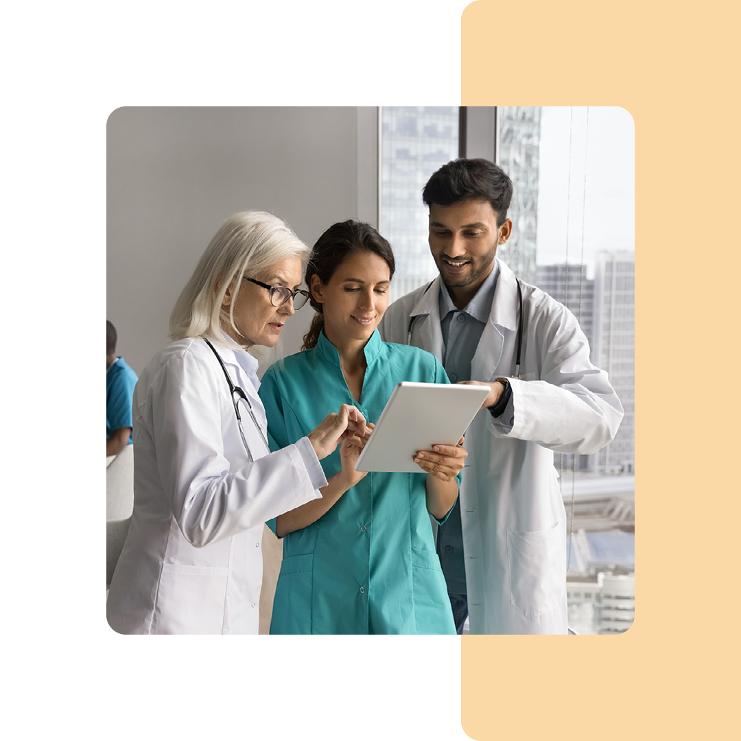 Image of a group of doctors stood looking at a tablet