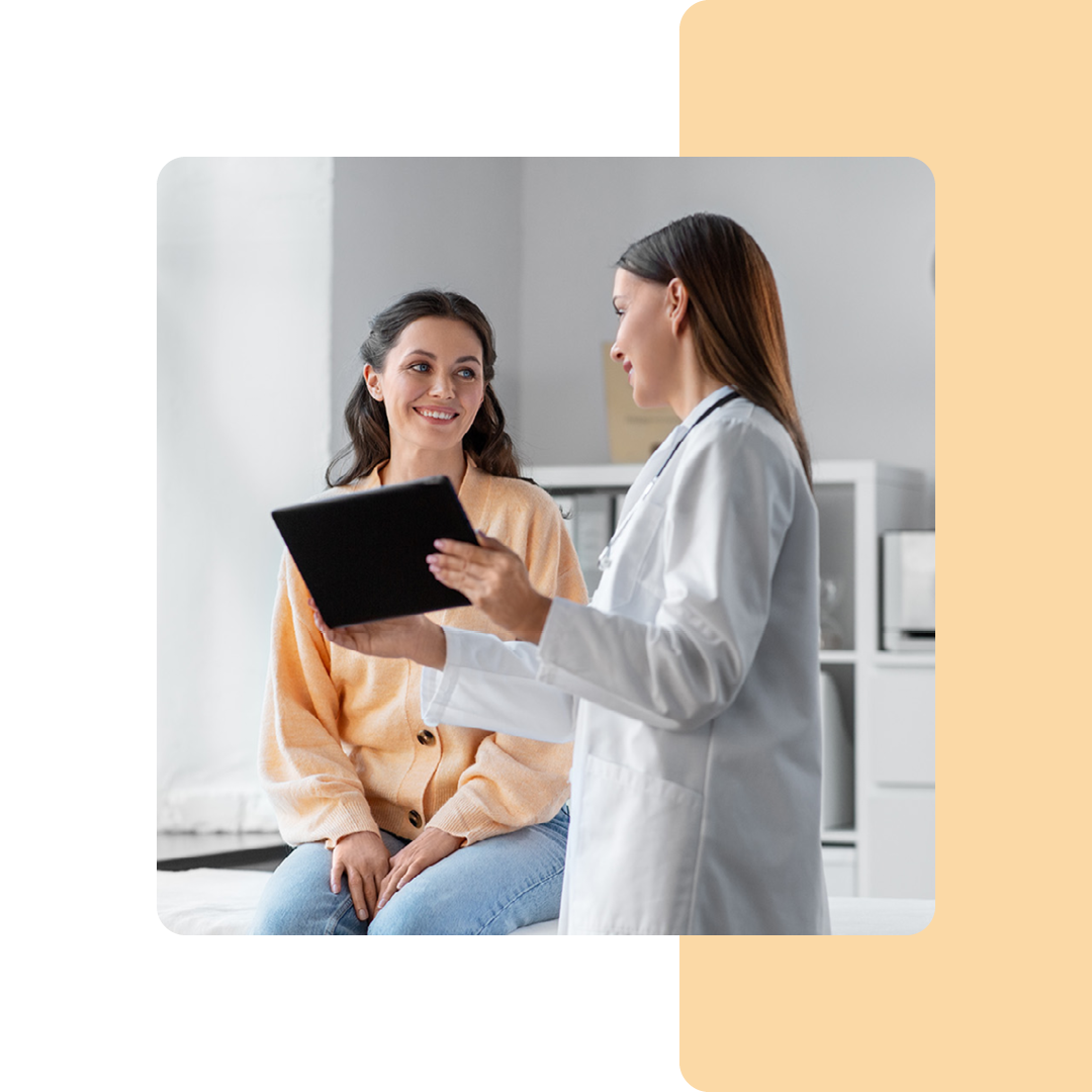 Image of a doctor stood showing a patient information on a tablet