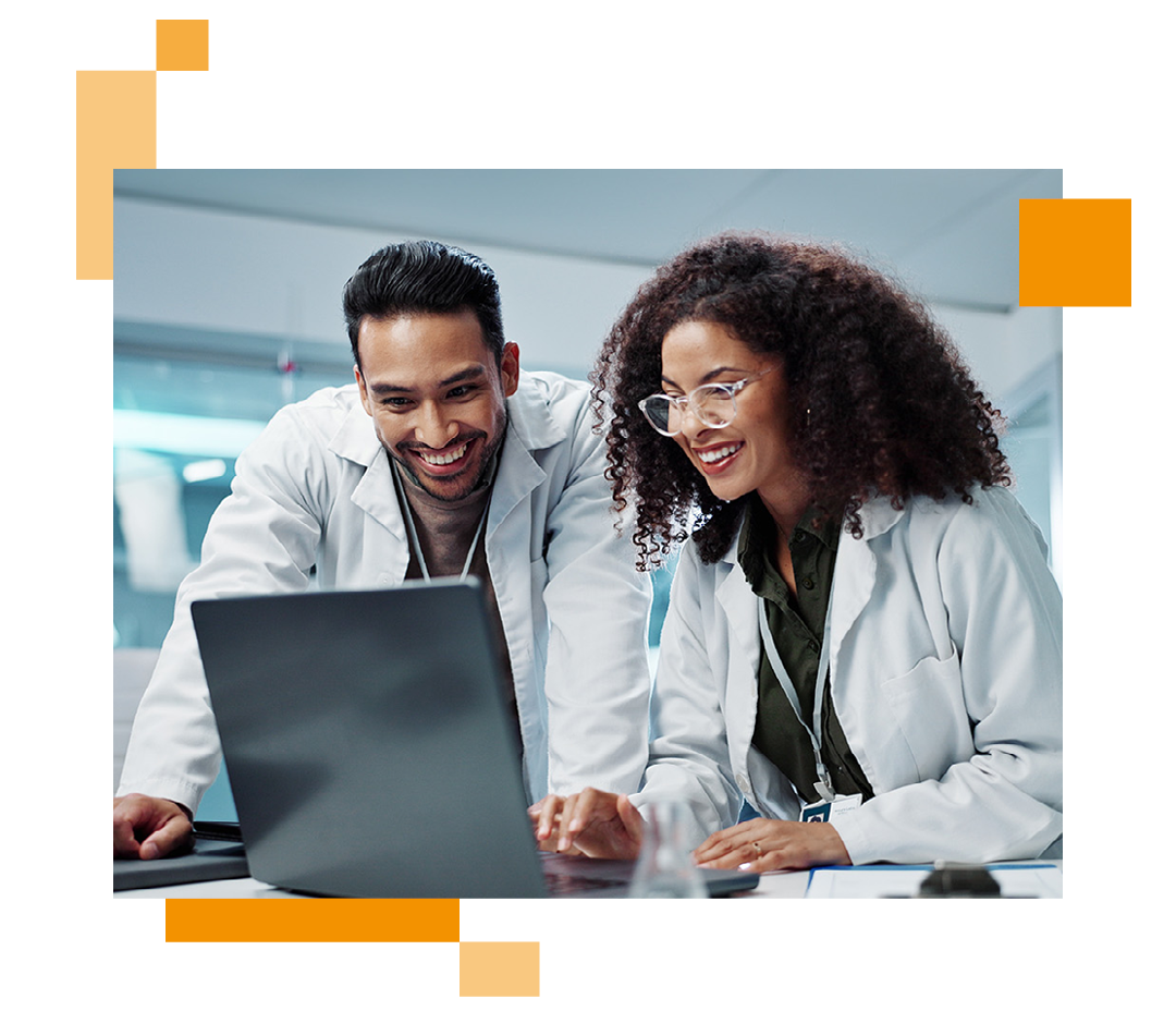 Image of two doctors looking at information on a laptop