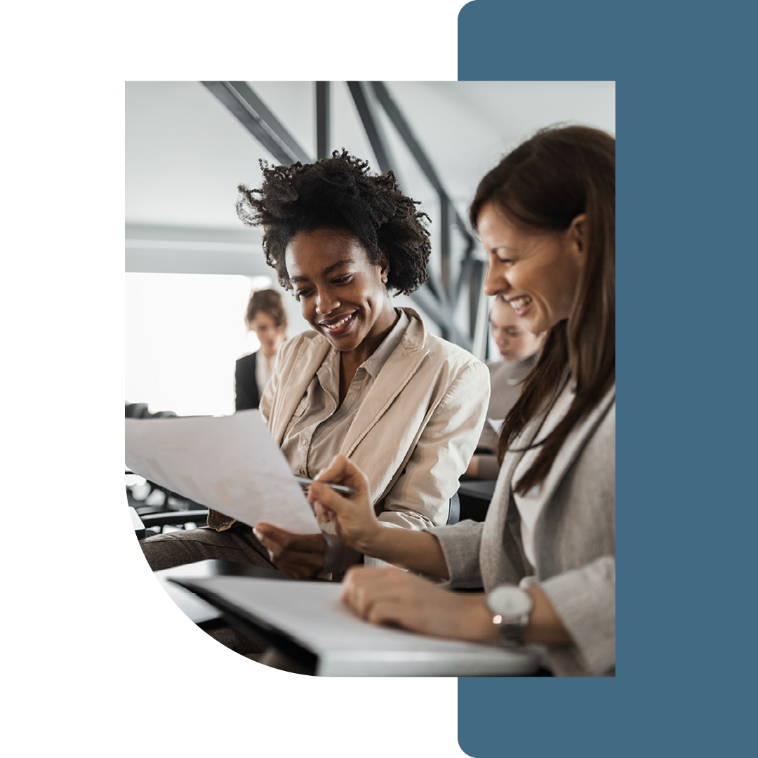 Image of two people working through documents together