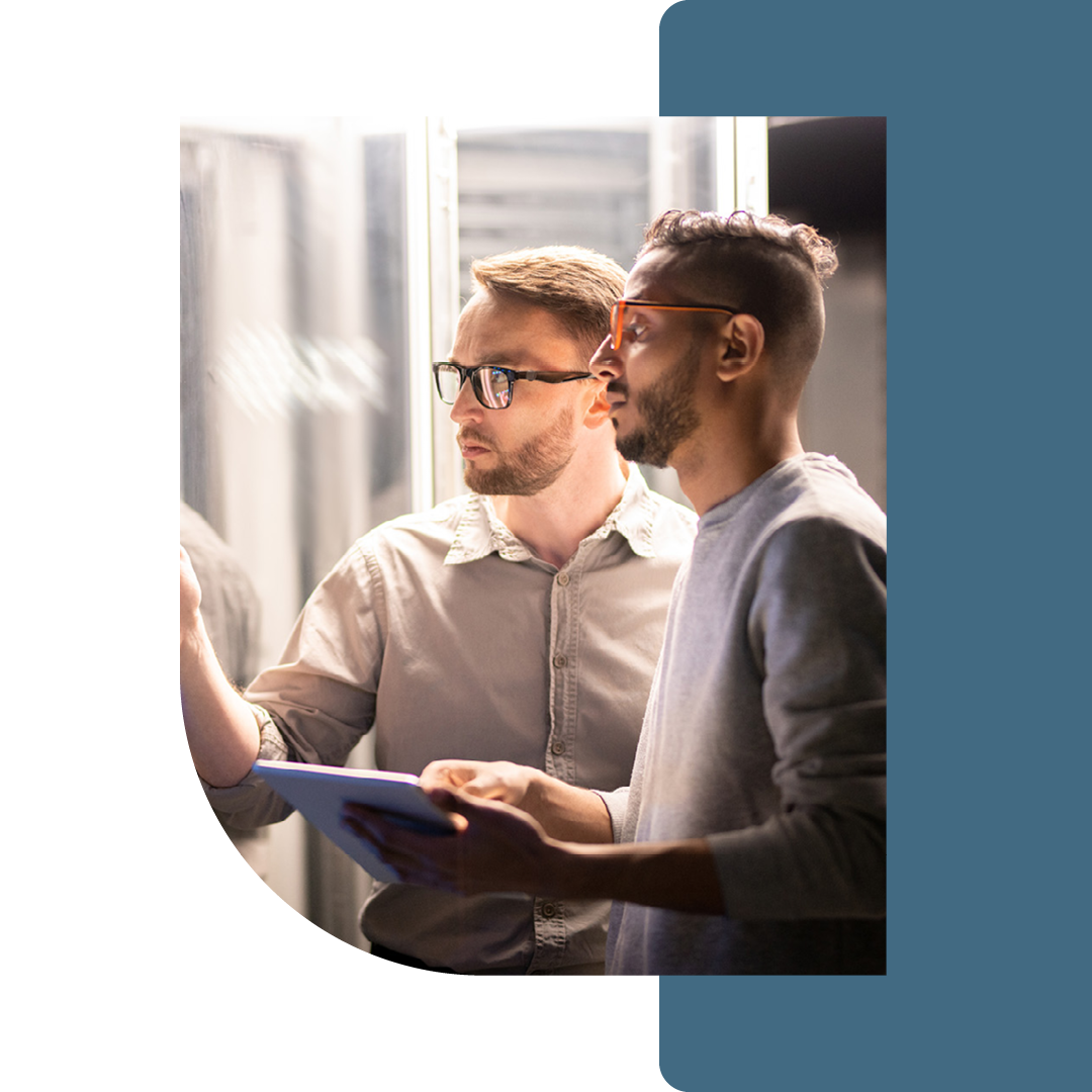 Image of two people working in a server room together