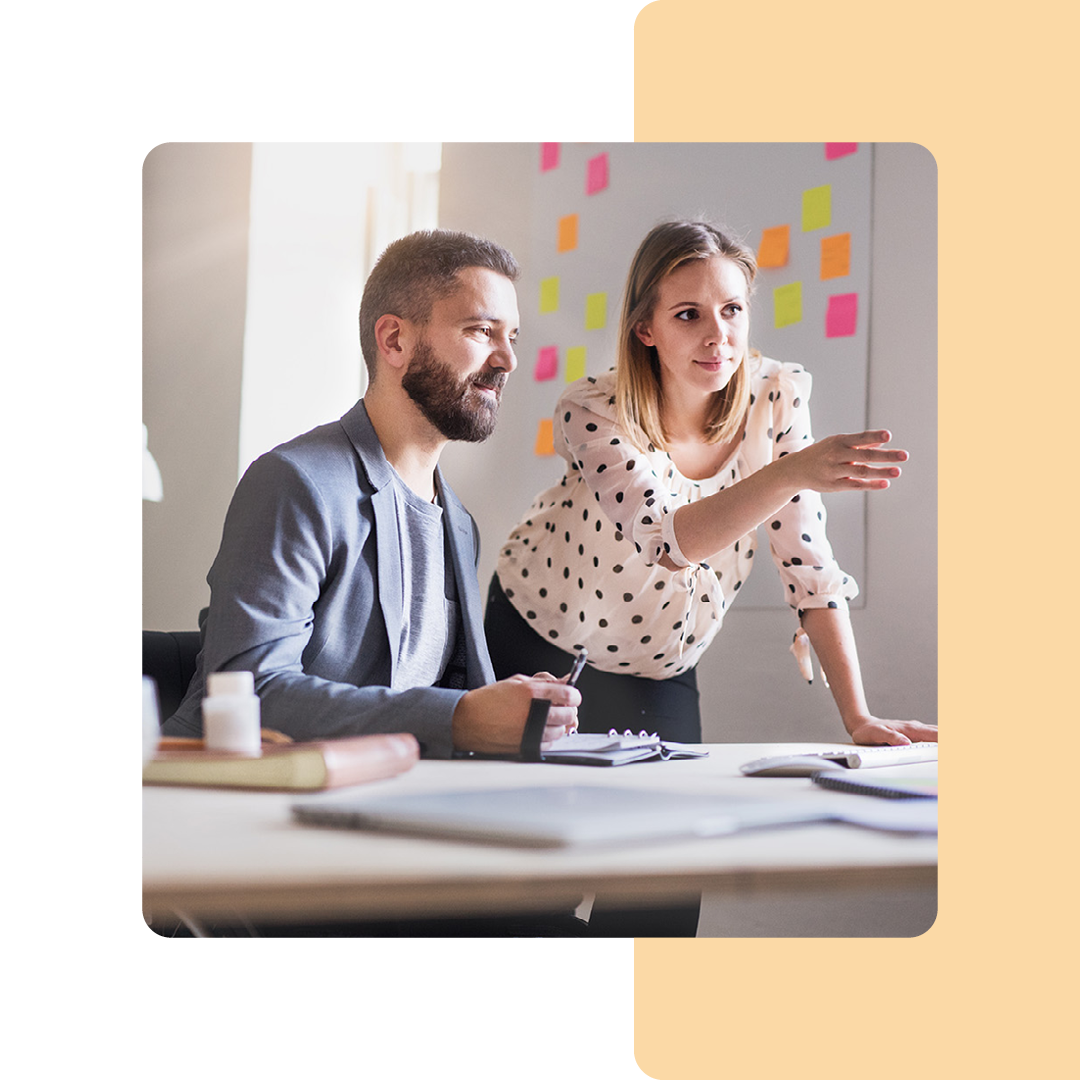 Image of two colleagues working together on a computer