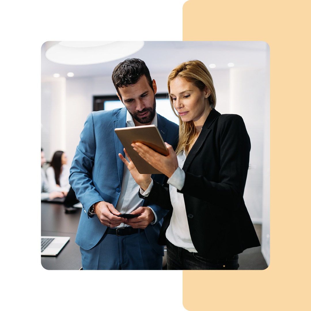 Image of two colleagues working together on a tablet