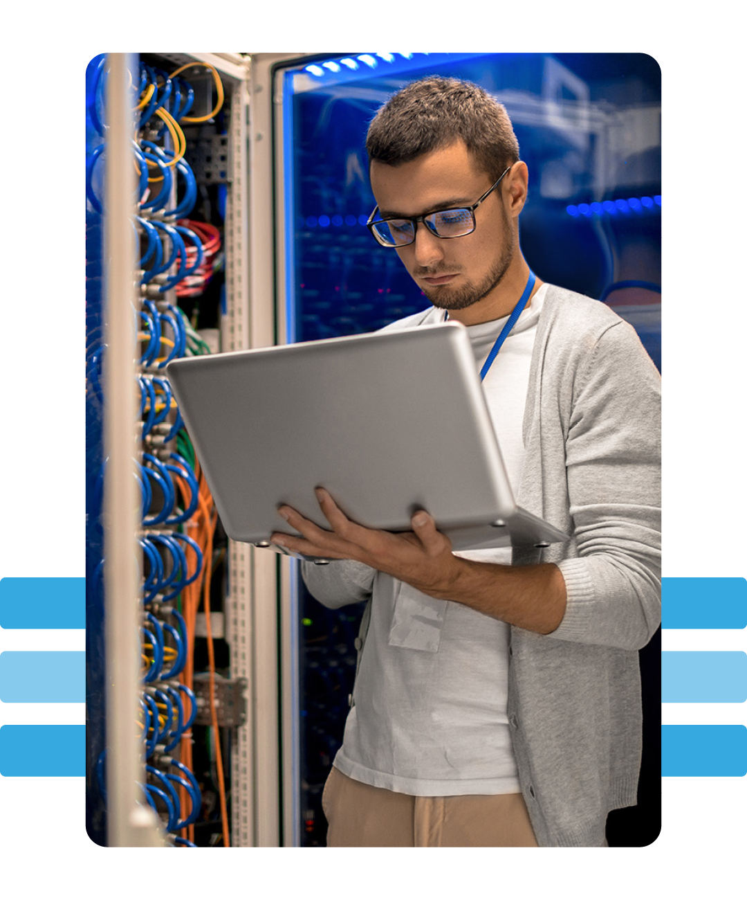 Image of a data protection specialists working on a laptop in a server room