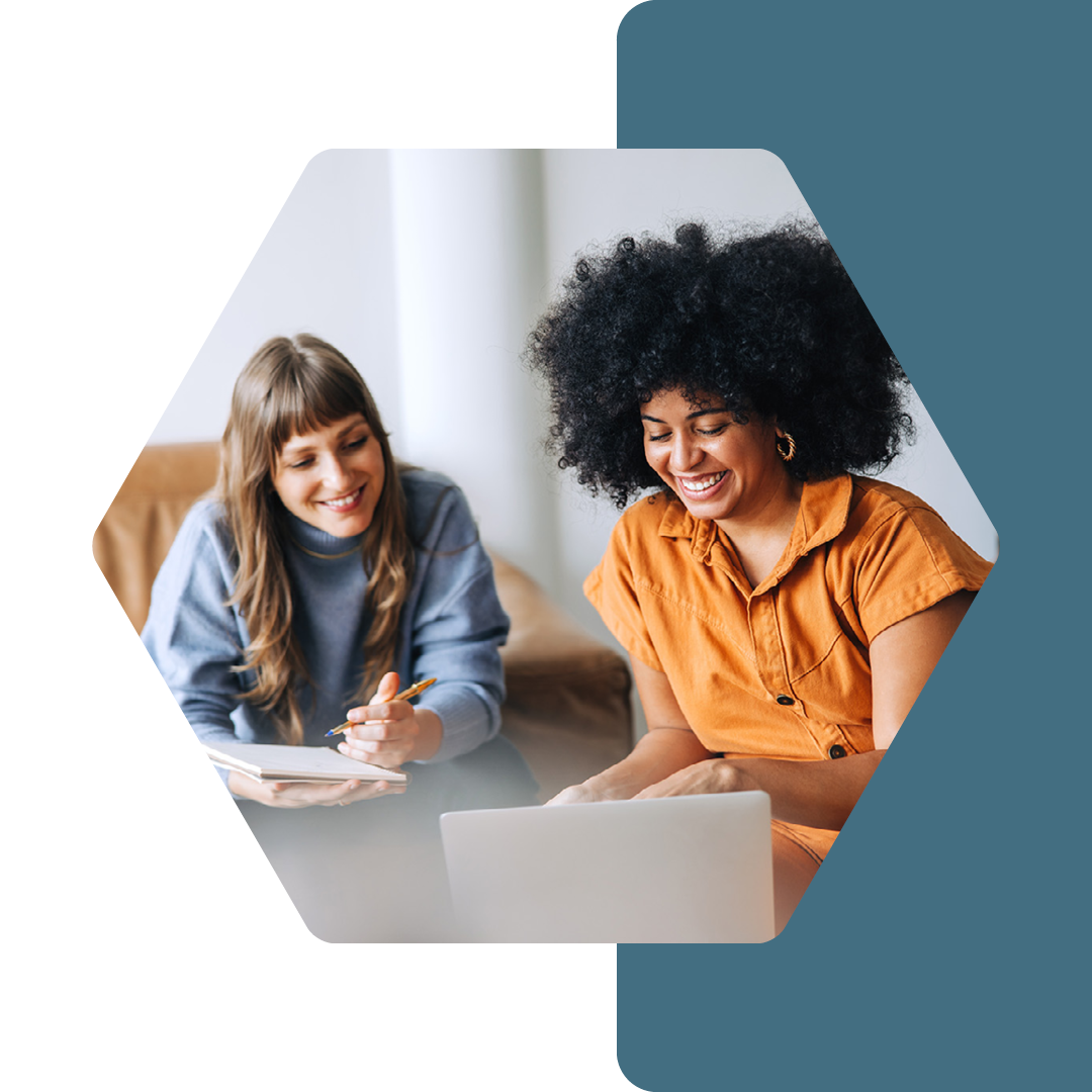 Image of two people working together on a laptop