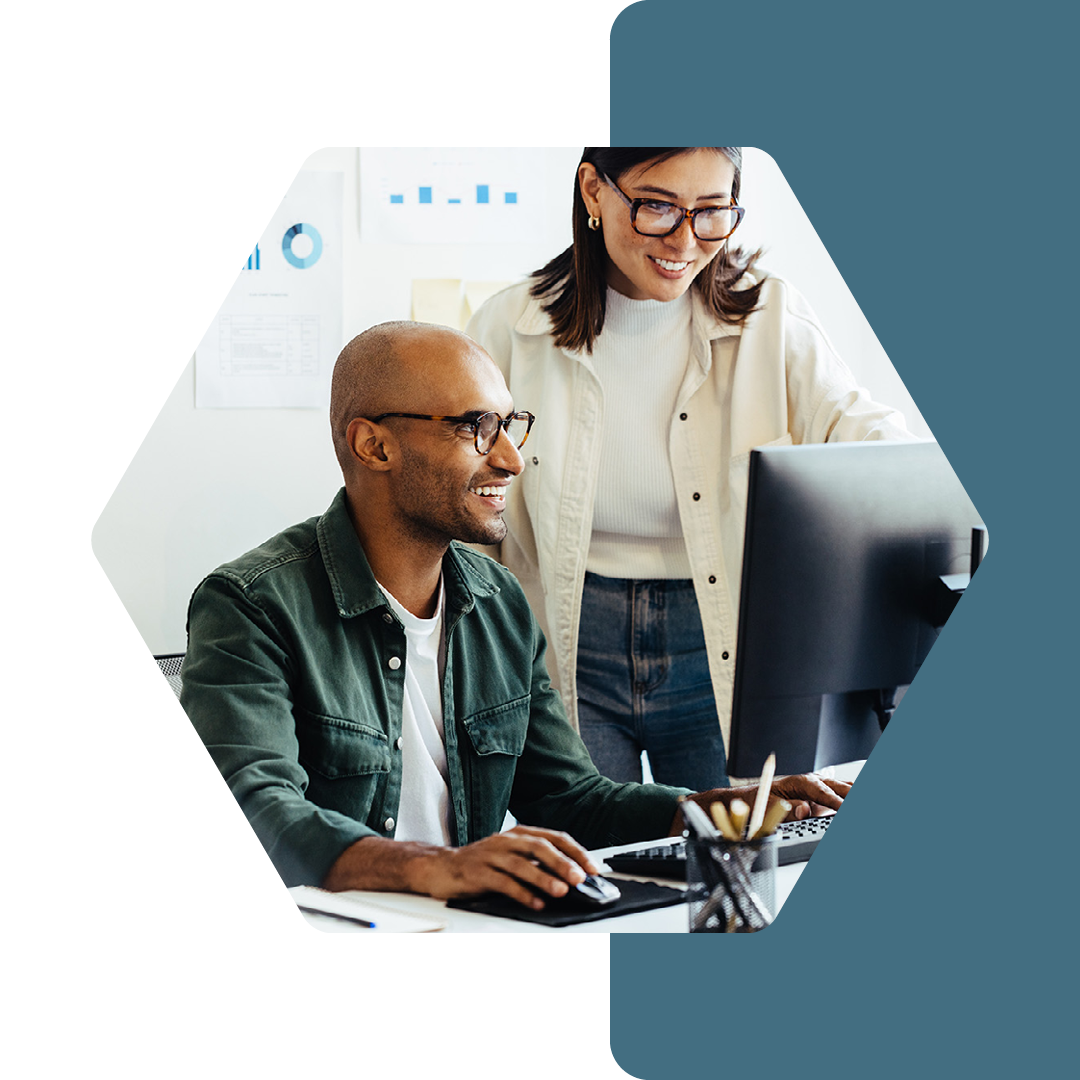 Image of two people working together on a computer