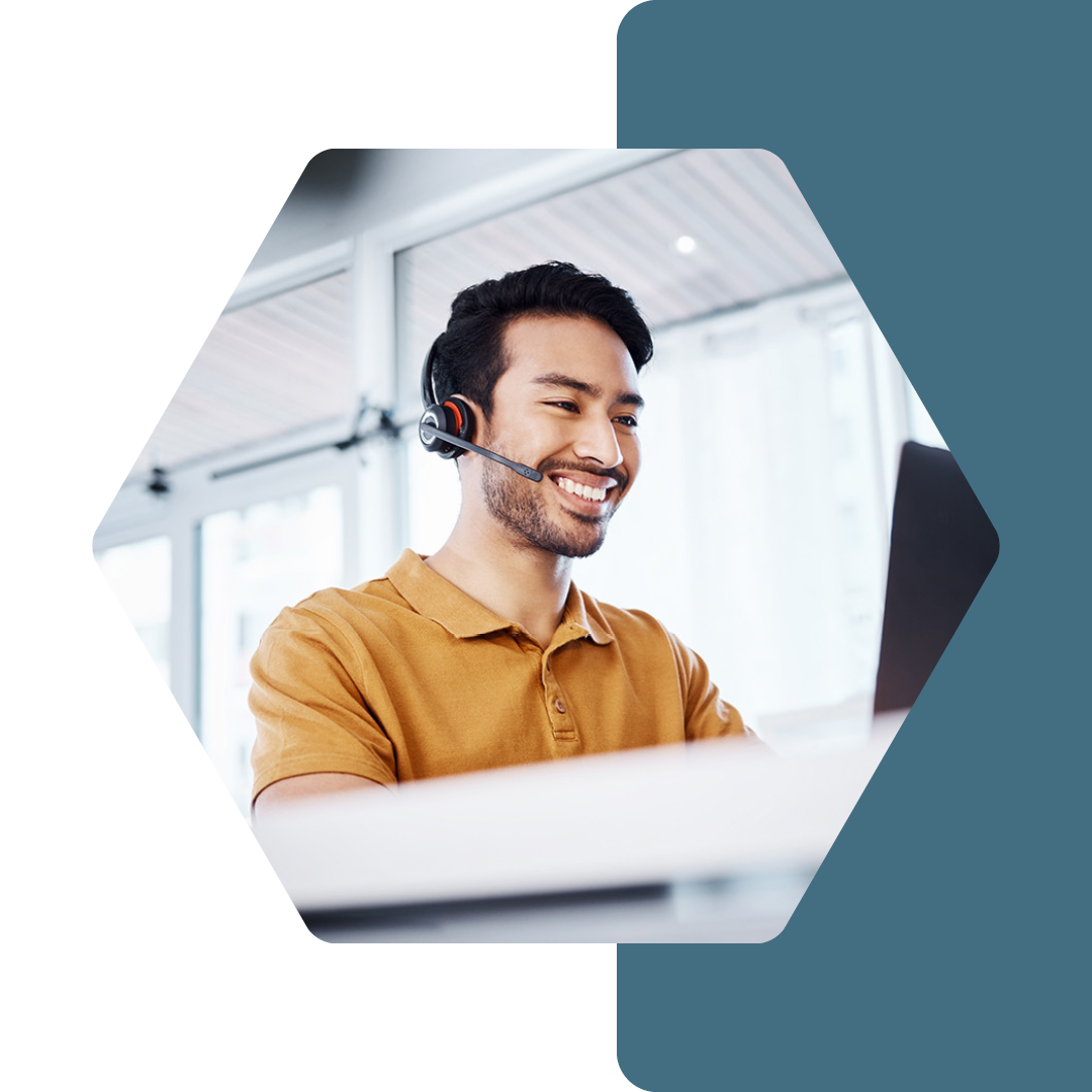 Image of a person at a desk talking on a headset