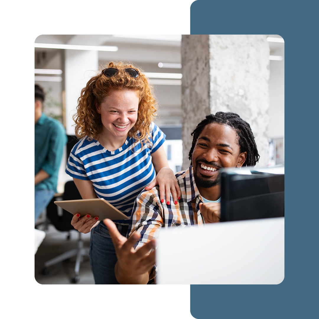 Image of two colleagues sat collaborating at a desk