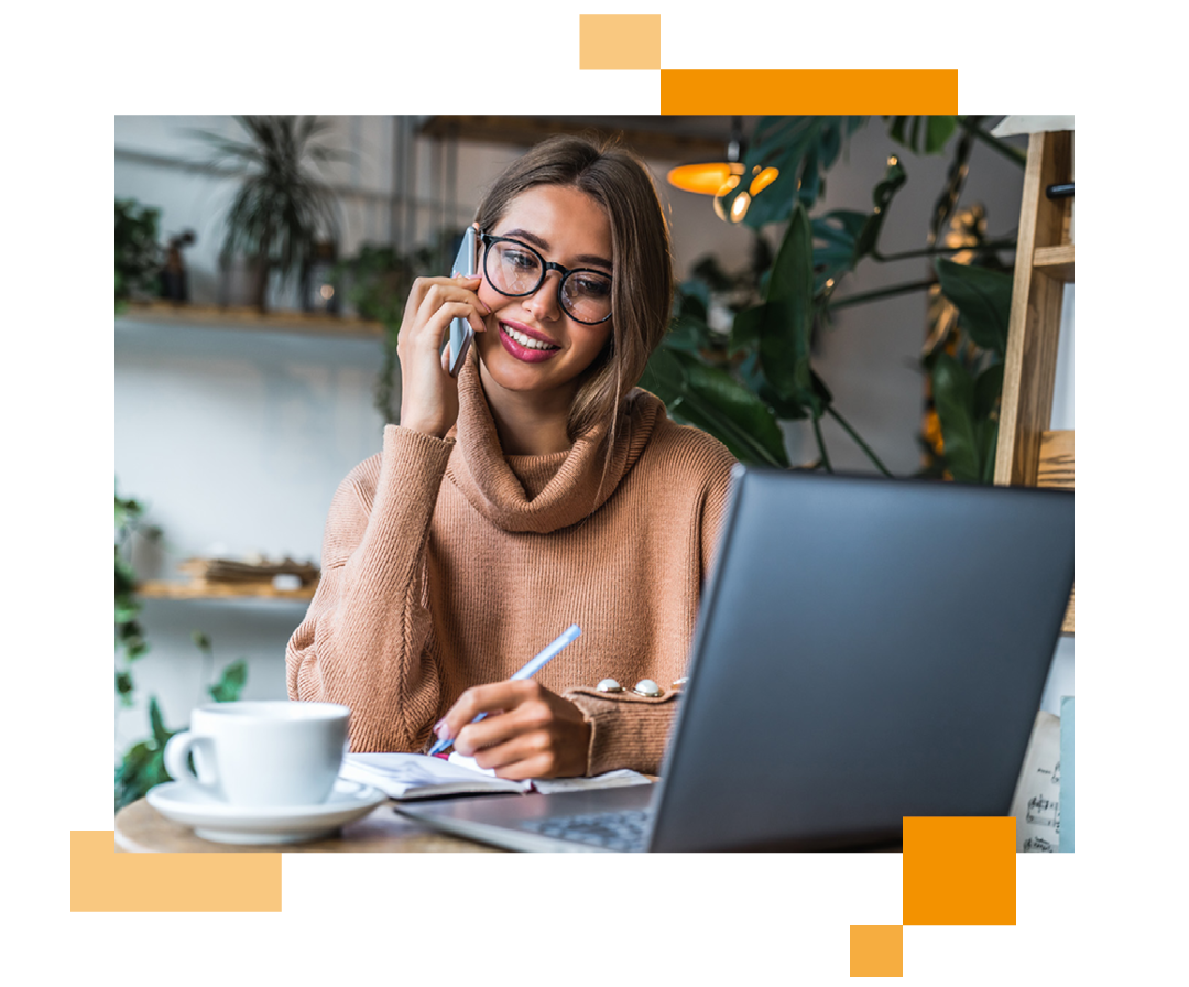 Image of a remote worker talking on a mobile phone and working on a laptop