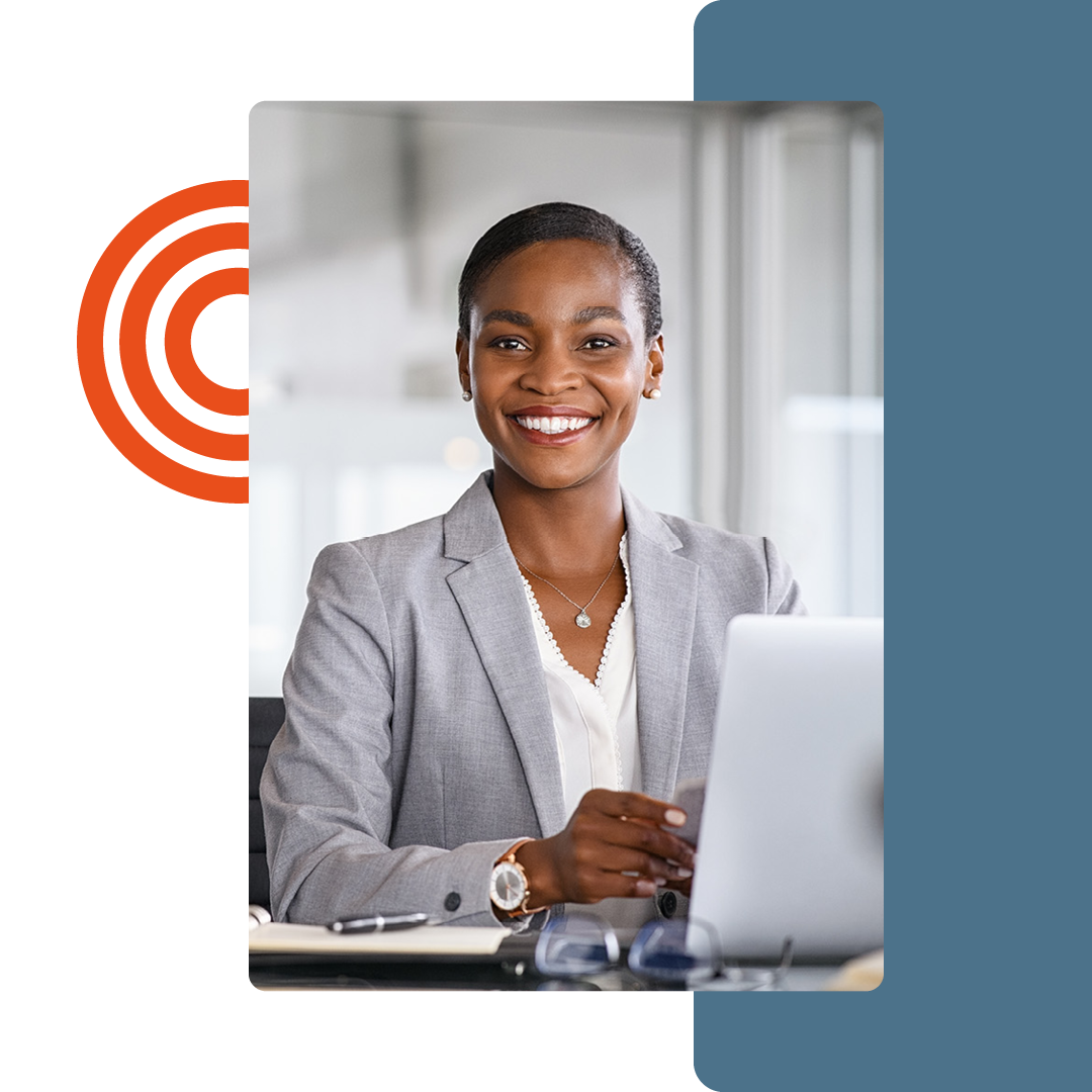 Image of a smiling person working at a desk