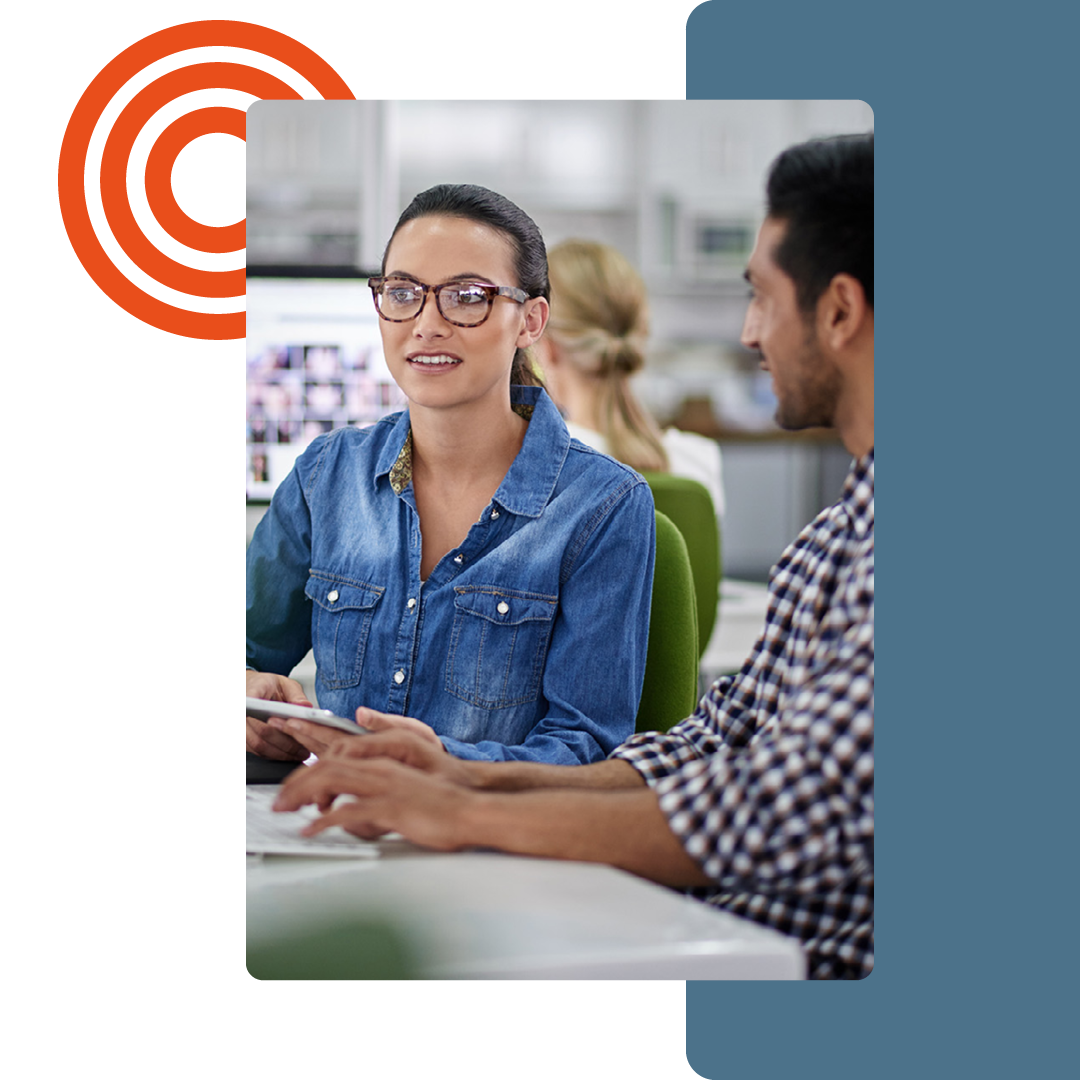 Image of two people working together at a desk