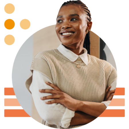 Image of a smiling working professional stood with arms folded