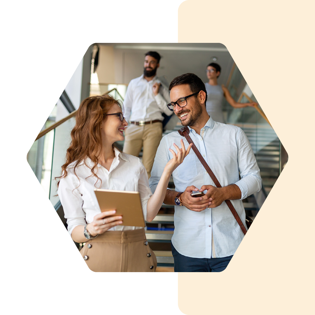 Image of two people walking down stairs talking