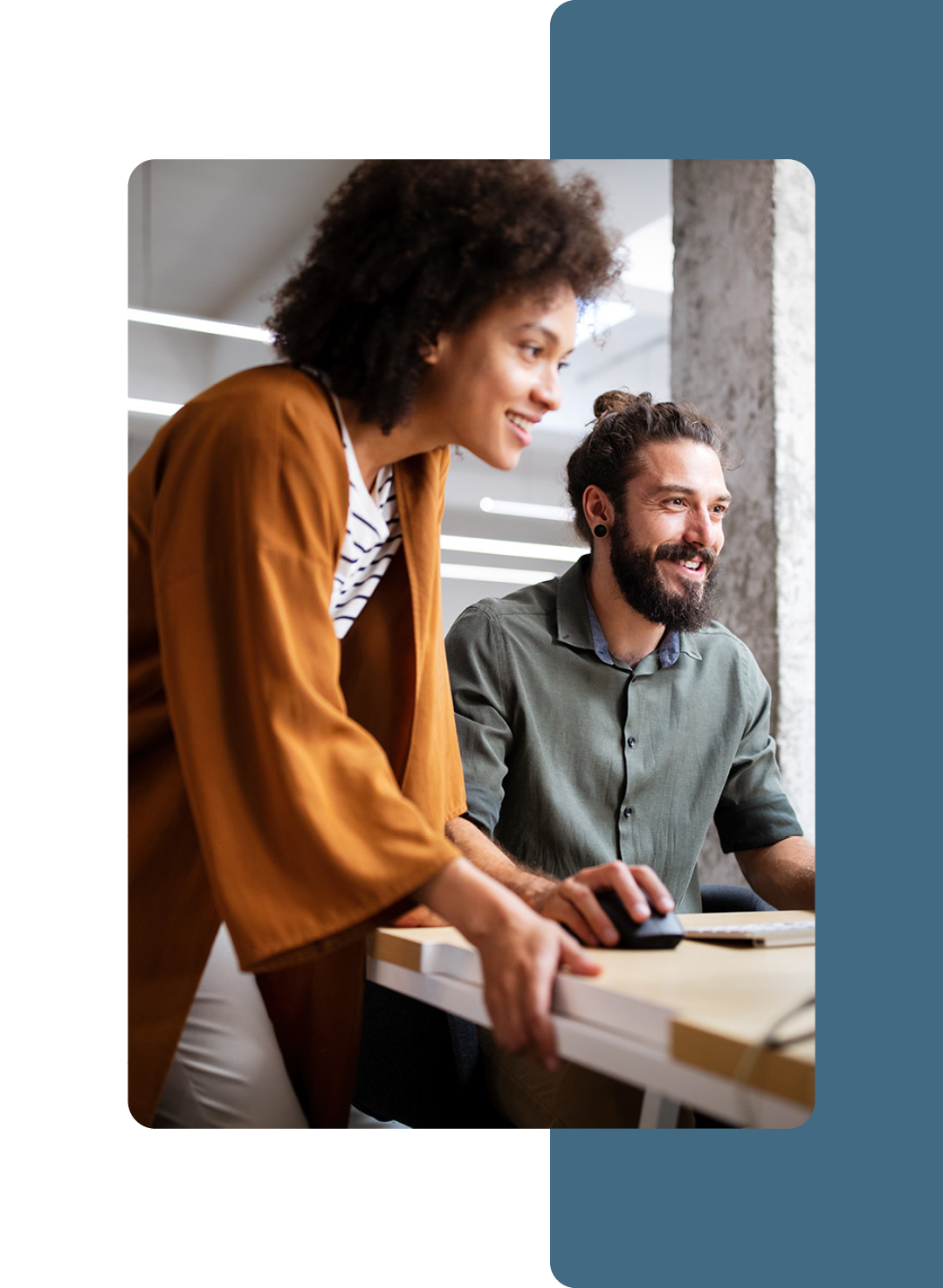 Image of two colleagues collaborating at a computer