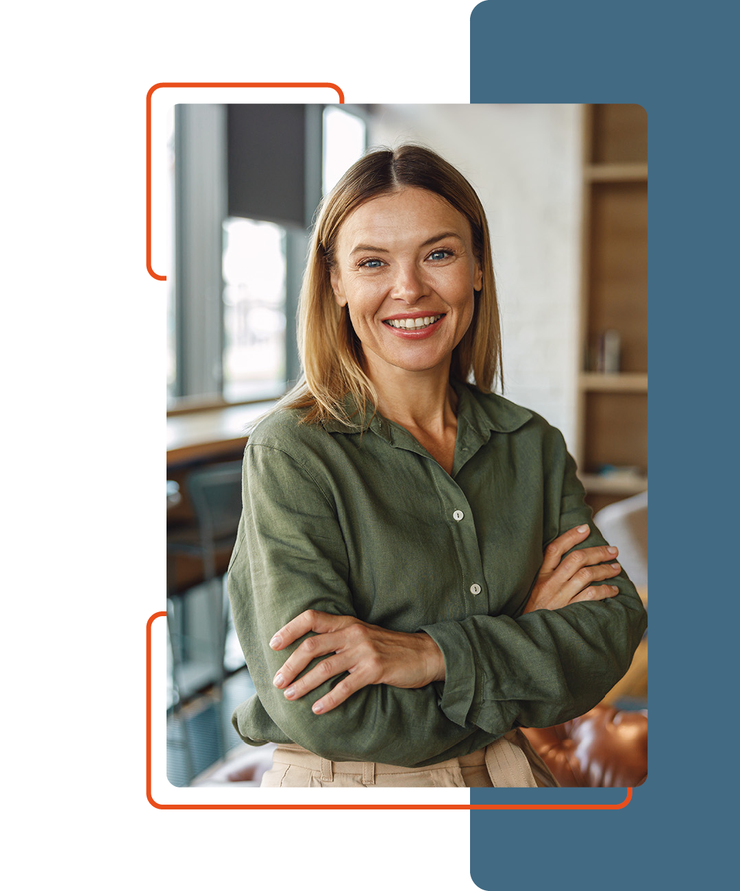 Image of a person smiling with their arms crossed stood up in an office