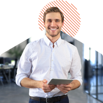 Image of a smiling person holding a tablet on an office background