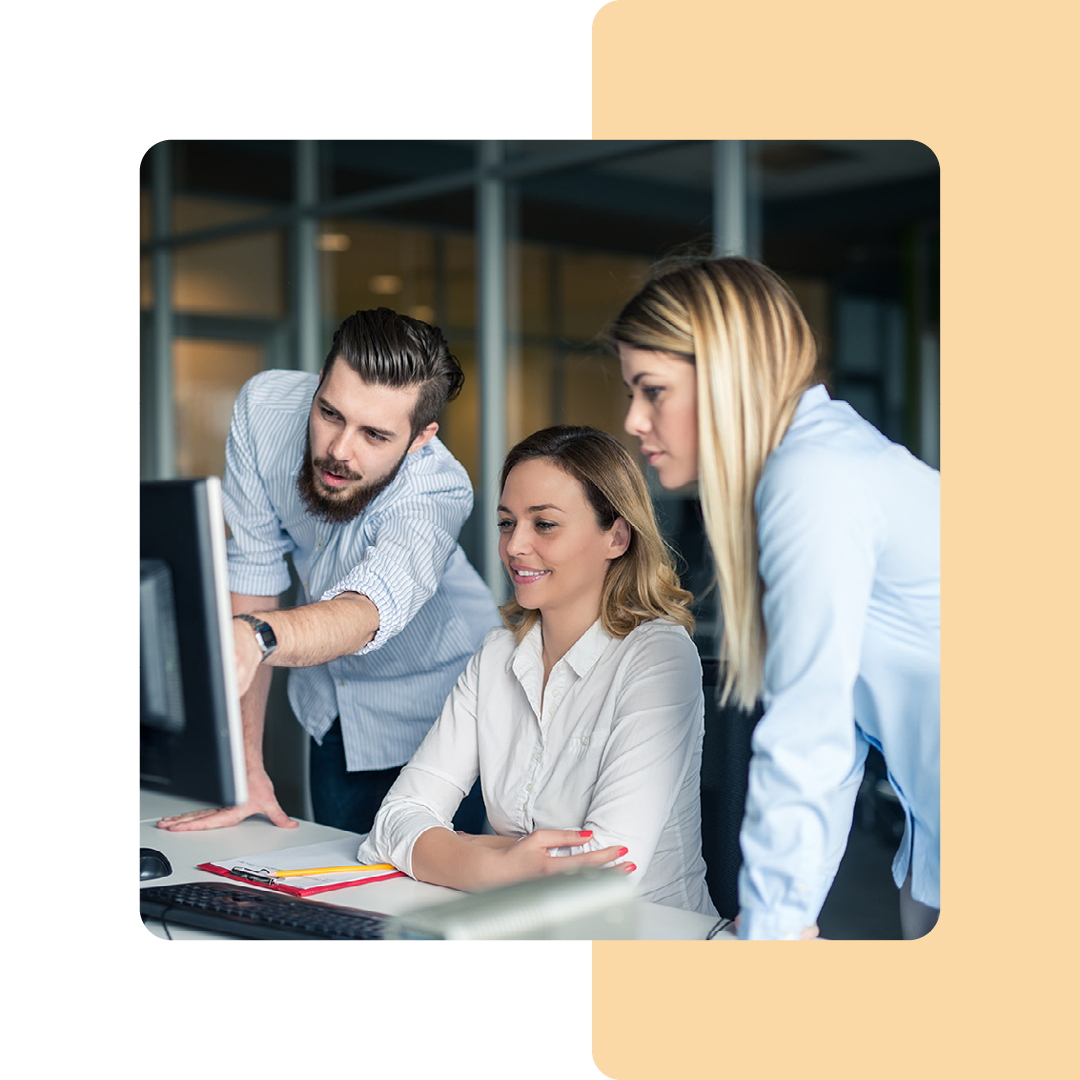 Image of a group of coworkers collaborating around a laptop