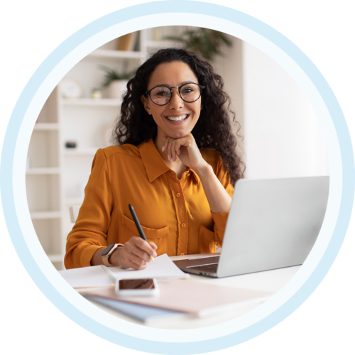 Image of a smiling work professional working on a laptop